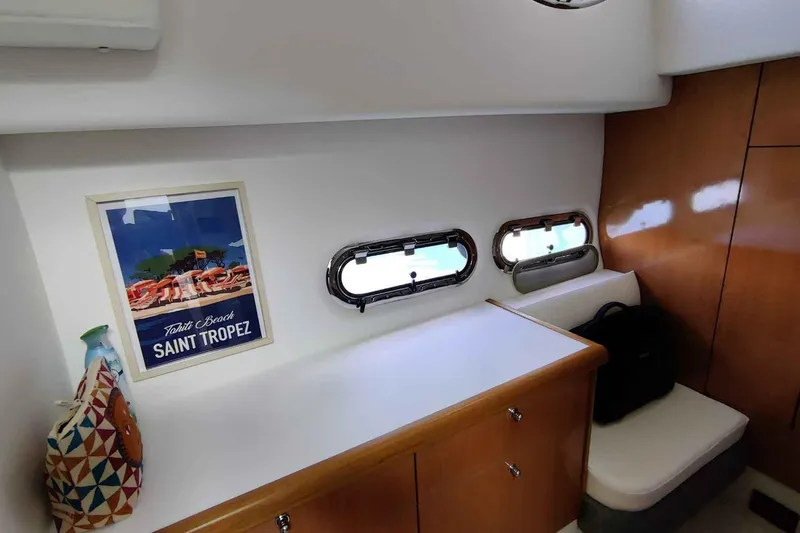 Ocilo Yacht Photos Pics Interior of 2005 Sealine SC 39 yacht with Saint Tropez poster and porthole windows.