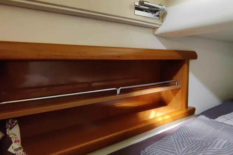 Ocilo Yacht Photos Pics Wooden shelf inside 2005 Sealine SC 39 boat cabin, featuring a metal rail.