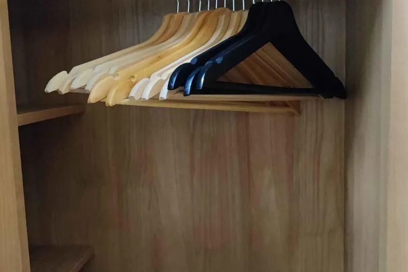 Ocilo Yacht Photos Pics Wooden closet with assorted hangers, inside a 2005 Sealine SC 39 yacht.