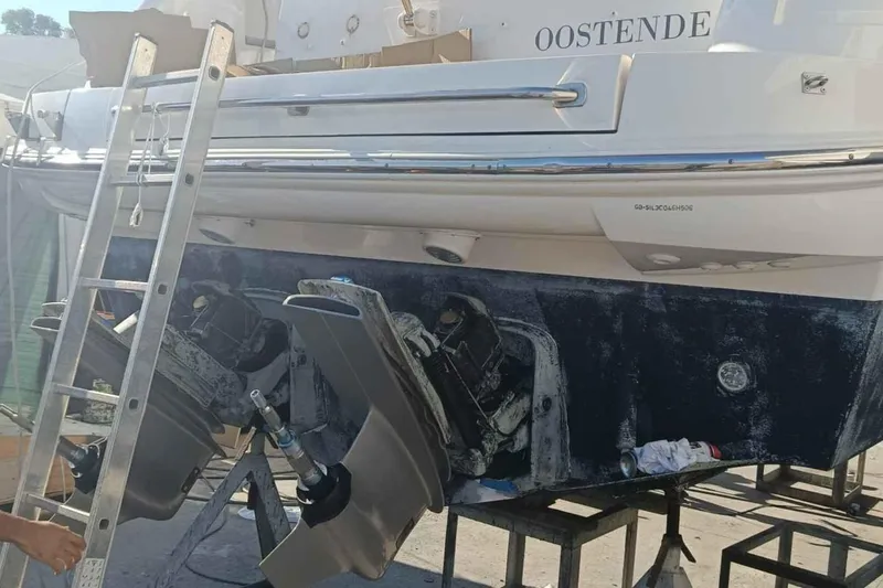 Ocilo Yacht Photos Pics 2005 Sealine SC 39 boat undergoing maintenance with visible propellers and ladder.