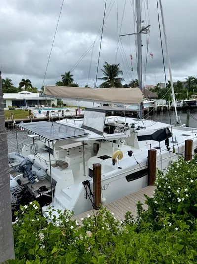 Cerebral Seabatical Yacht Photos Pics 2019 Fountaine Pajot Saona 47 catamaran docked by lush greenery.