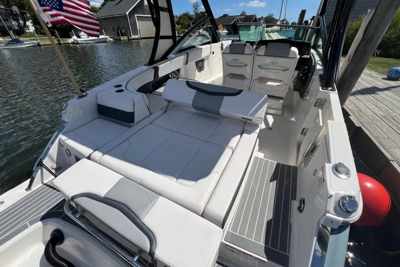  Yacht Photos Pics 2020 Chaparral 280 OSX boat interior with seating, docked by a waterfront.