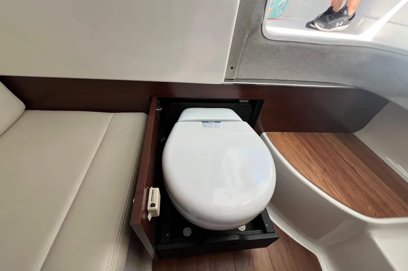 Yacht Photos Pics 2020 Chaparral 280 OSX boat interior with a compact, pull-out toilet design.