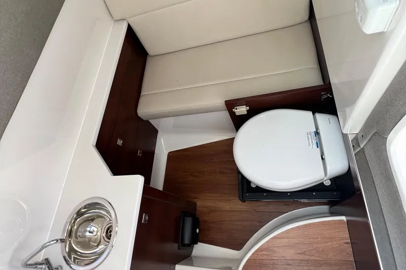  Yacht Photos Pics 2020 Chaparral 280 OSX boat interior with compact bathroom and sink.