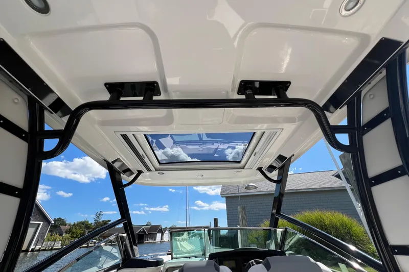  Yacht Photos Pics 2020 Chaparral 280 OSX boat interior with sunroof, docked near waterfront homes.