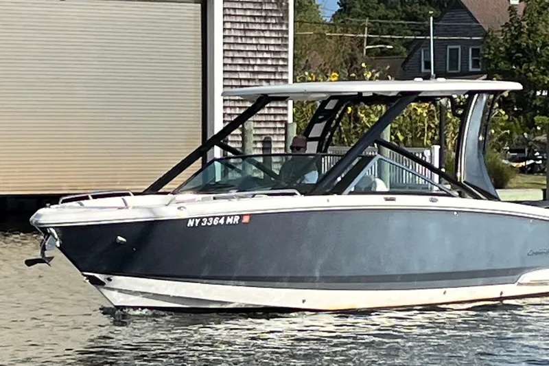  Yacht Photos Pics 2020 Chaparral 280 OSX boat docked near a waterfront building.