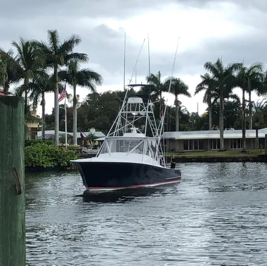  Yacht Photos Pics 1985 Hines-Farley Custom Express boat on a tropical waterway with palm trees.