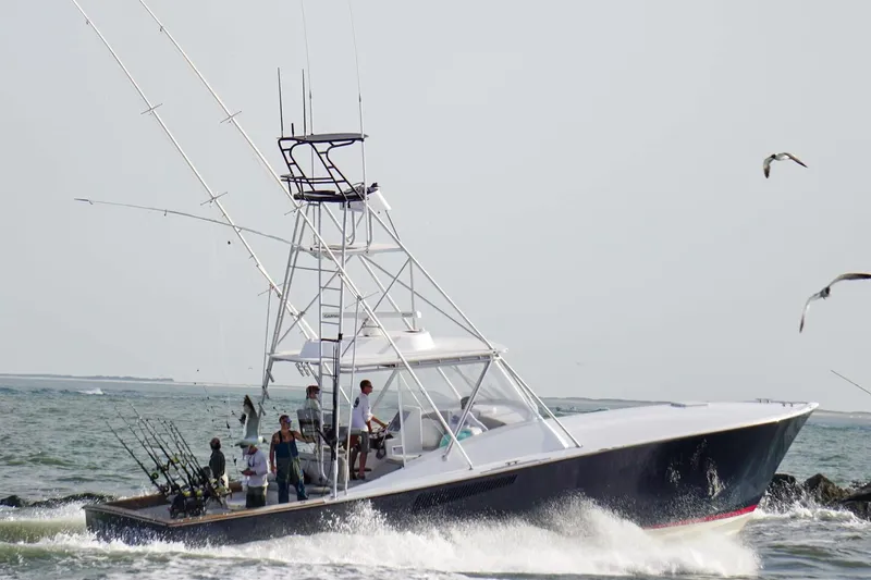  Yacht Photos Pics 1985 Hines-Farley Custom Express boat navigating ocean waves with fishing rods.