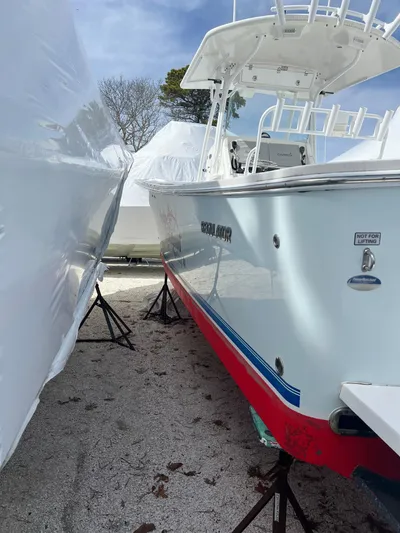 Angler Management Yacht Photos Pics 2013 Regulator 34 Center Console boat on stands, partially covered, outdoors.