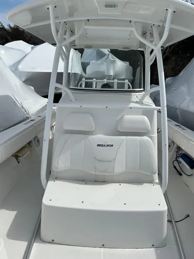 Angler Management Yacht Photos Pics 2013 Regulator 34 Center Console boat with white seating and T-top.