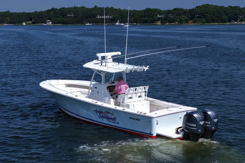 Angler Management Yacht Photos Pics 2013 Regulator 34 Center Console boat on water with dual Yamaha engines.