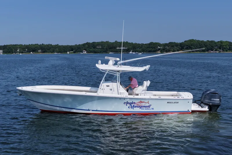 Angler Management Yacht Photos Pics 2013 Regulator 34 Center Console boat on water, side view, with Yamaha engines.