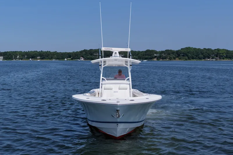 Angler Management Yacht Photos Pics 2013 Regulator 34 Center Console boat cruising on a calm lake.