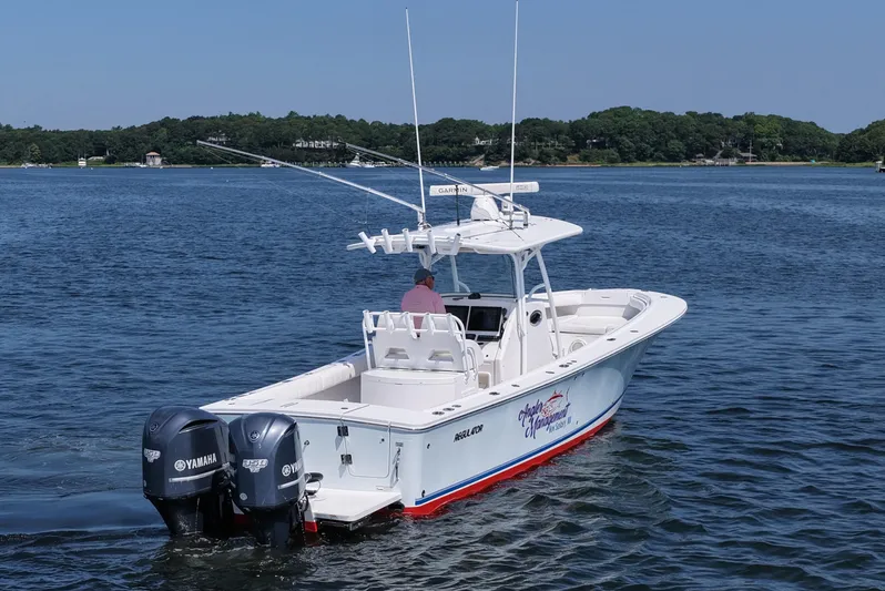 Angler Management Yacht Photos Pics 2013 Regulator 34 Center Console boat with twin Yamaha engines on a calm lake.