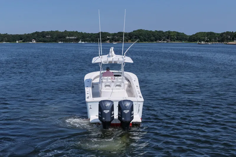 Angler Management Yacht Photos Pics 2013 Regulator 34 Center Console boat on calm water, rear view with twin engines.