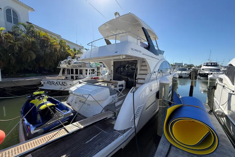  Yacht Photos Pics 2017 Schaefer 56 yacht docked at marina with jet ski and rolled mat nearby.