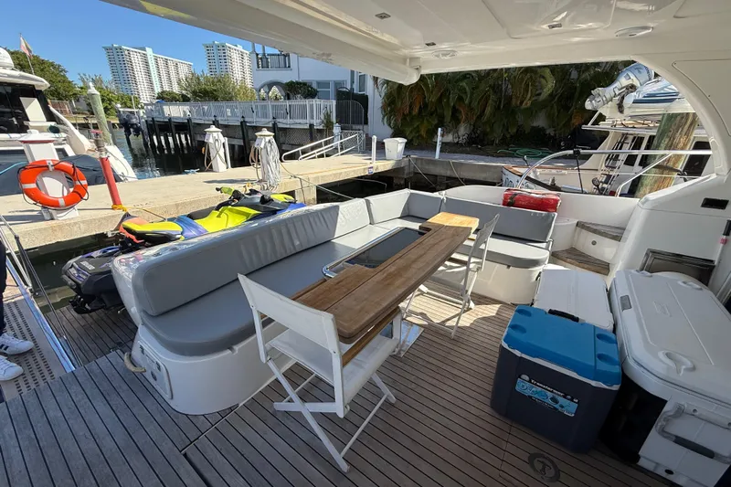 Yacht Photos Pics Luxurious 2017 Schaefer 56 yacht deck with seating, table, and coolers at a marina.