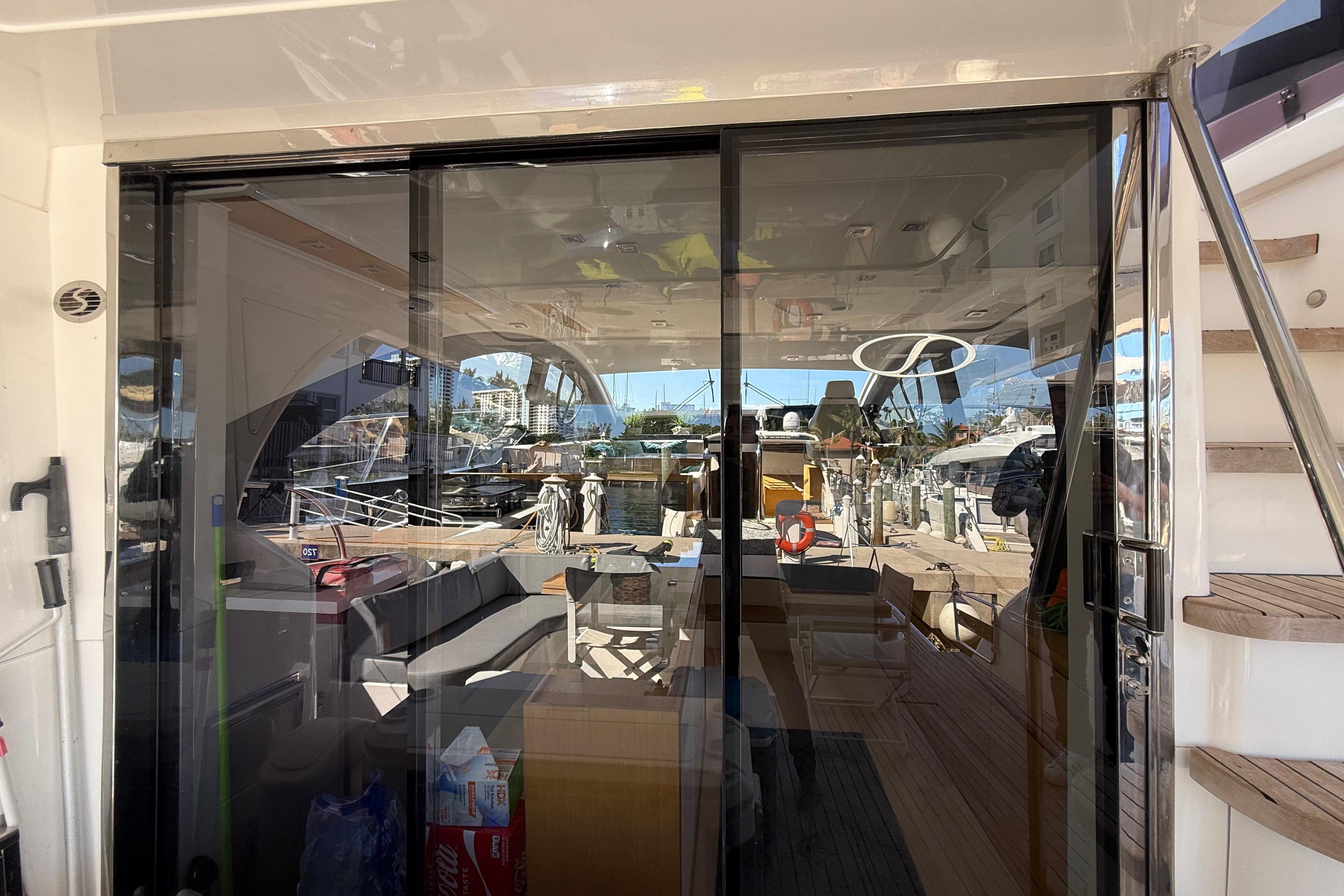 Luxurious 2017 Schaefer 56 yacht interior with glass doors and marina view.