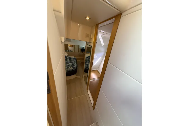  Yacht Photos Pics Narrow hallway in 2017 Schaefer 56 yacht with mirrored door and cozy bedroom.