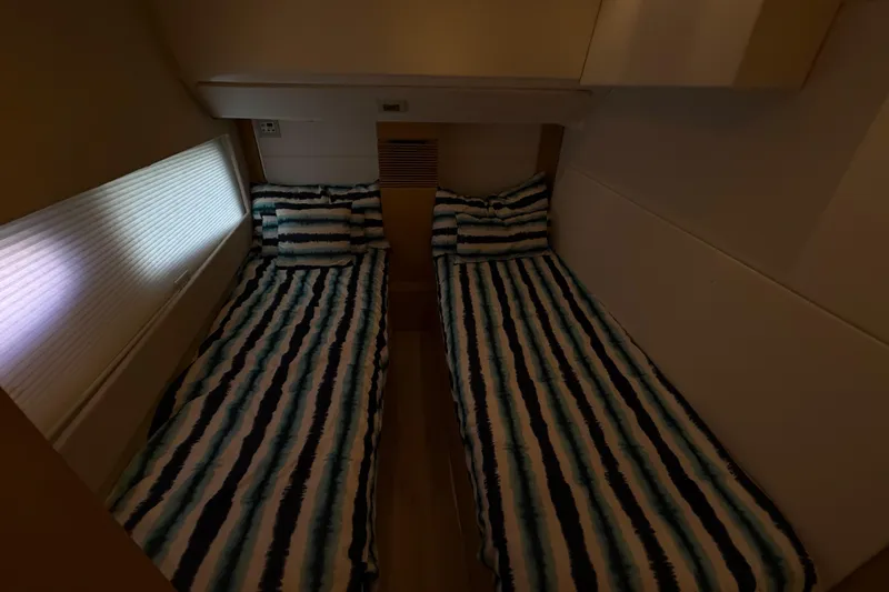  Yacht Photos Pics Twin beds with striped bedding in a 2017 Schaefer 56 yacht cabin.