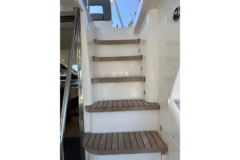  Yacht Photos Pics Staircase on 2017 Schaefer 56 yacht with wooden steps and white railing.
