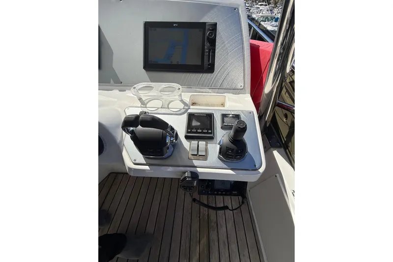  Yacht Photos Pics Control panel of a 2017 Schaefer 56 yacht with navigation screen and joystick.