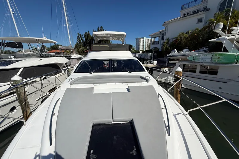  Yacht Photos Pics Luxury Schaefer 56 yacht from 2017 docked at marina under clear blue sky.