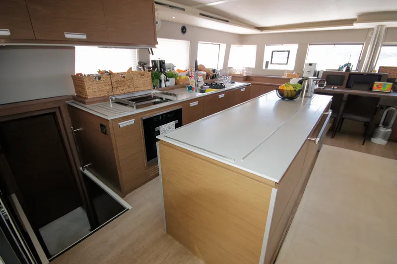  Yacht Photos Pics Luxurious kitchen interior of 2019 Lagoon 620 Essense yacht with modern appliances and sleek design.