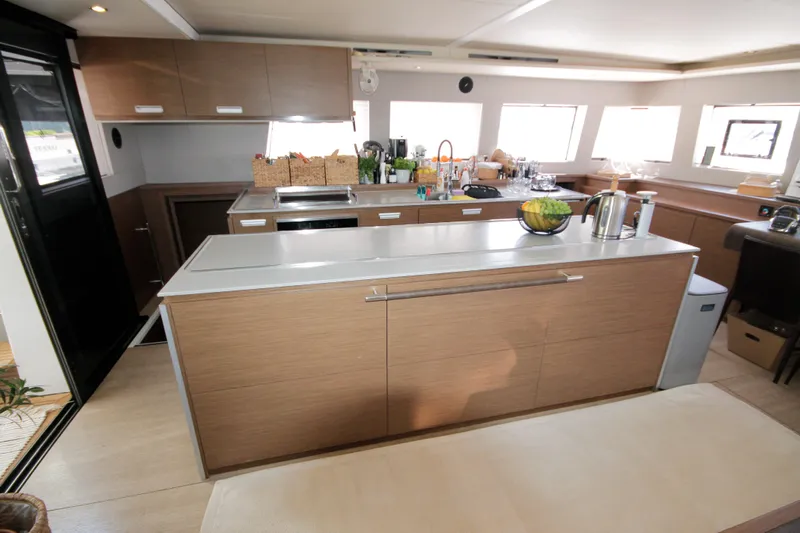  Yacht Photos Pics Modern kitchen interior of 2019 Lagoon 620 Essense yacht with sleek cabinetry and appliances.
