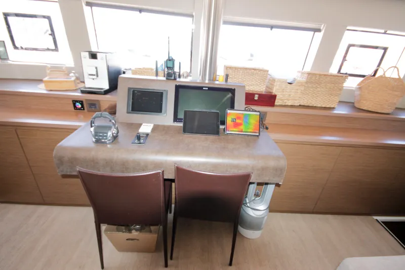  Yacht Photos Pics Navigation station of 2019 Lagoon 620 Essense yacht with modern equipment and seating.