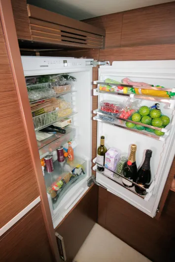 Yacht Photos Pics Open refrigerator in Lagoon 620 Essense yacht, stocked with beverages, fruits, and groceries.