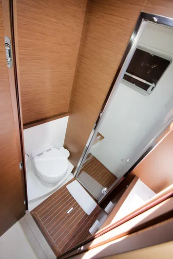  Yacht Photos Pics 2019 Lagoon 620 Essense yacht bathroom with wooden accents and modern fixtures.