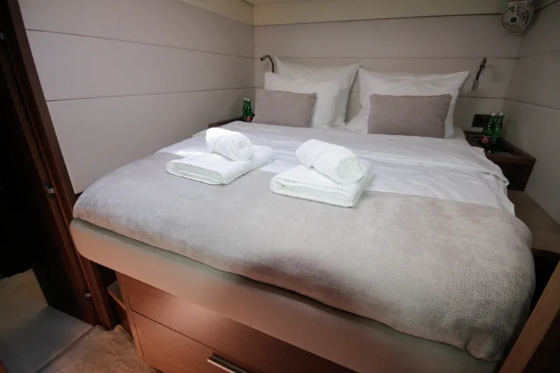  Yacht Photos Pics Luxurious bedroom interior of 2019 Lagoon 620 Essense yacht with neatly arranged towels.