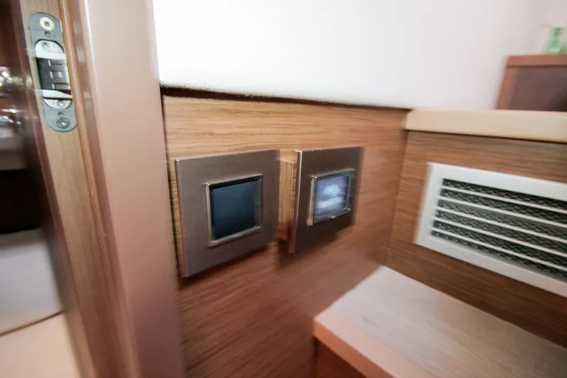  Yacht Photos Pics Interior control panel on 2019 Lagoon 620 Essense yacht, featuring modern design and wood finish.