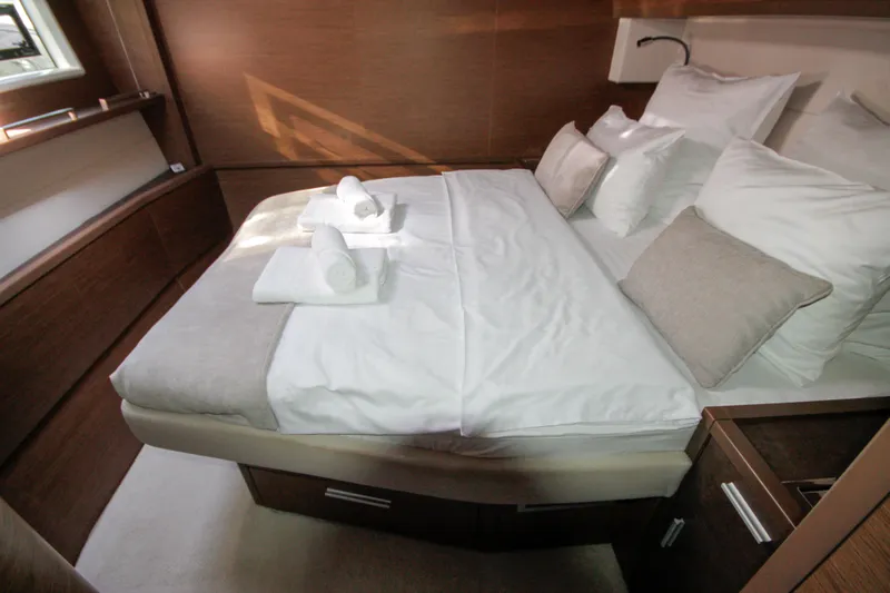 Yacht Photos Pics Luxurious bedroom interior of 2019 Lagoon 620 Essense yacht with neatly arranged bedding.