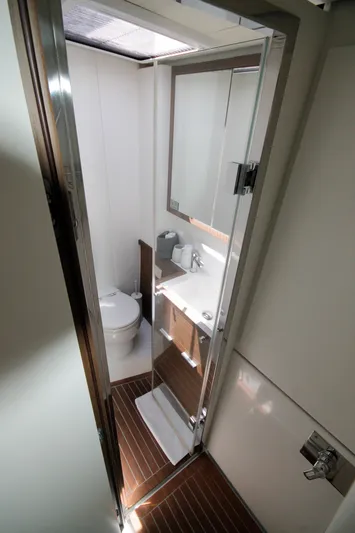  Yacht Photos Pics Luxurious bathroom in 2019 Lagoon 620 Essense yacht with modern fixtures and wooden flooring.