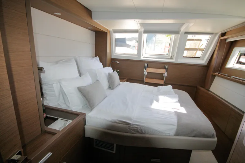  Yacht Photos Pics Luxurious cabin interior of 2019 Lagoon 620 Essense yacht with cozy bed and natural light.
