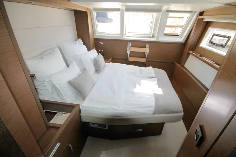  Yacht Photos Pics Luxurious cabin interior of 2019 Lagoon 620 Essense yacht with modern design and cozy bedding.