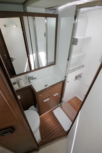  Yacht Photos Pics Luxurious bathroom in 2019 Lagoon 620 Essense yacht with modern fixtures and wood accents.