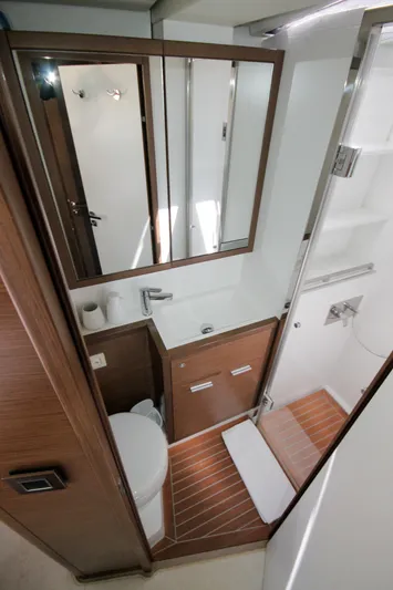  Yacht Photos Pics Luxurious bathroom in 2019 Lagoon 620 Essense yacht with modern fixtures and wood accents.