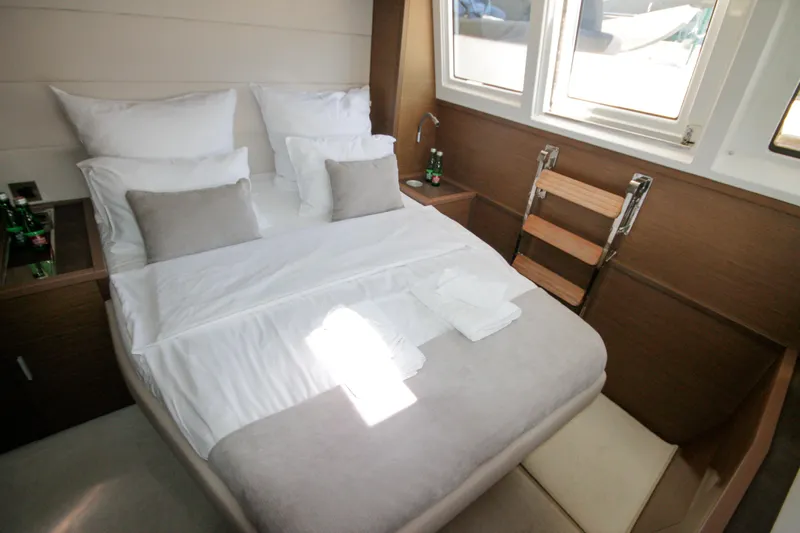  Yacht Photos Pics Luxurious cabin interior of 2019 Lagoon 620 Essense yacht with cozy bed and natural light.