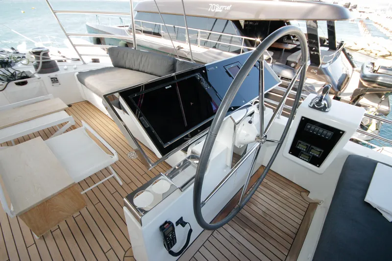  Yacht Photos Pics Luxurious 2019 Lagoon 620 Essense yacht helm with modern navigation equipment and spacious seating.