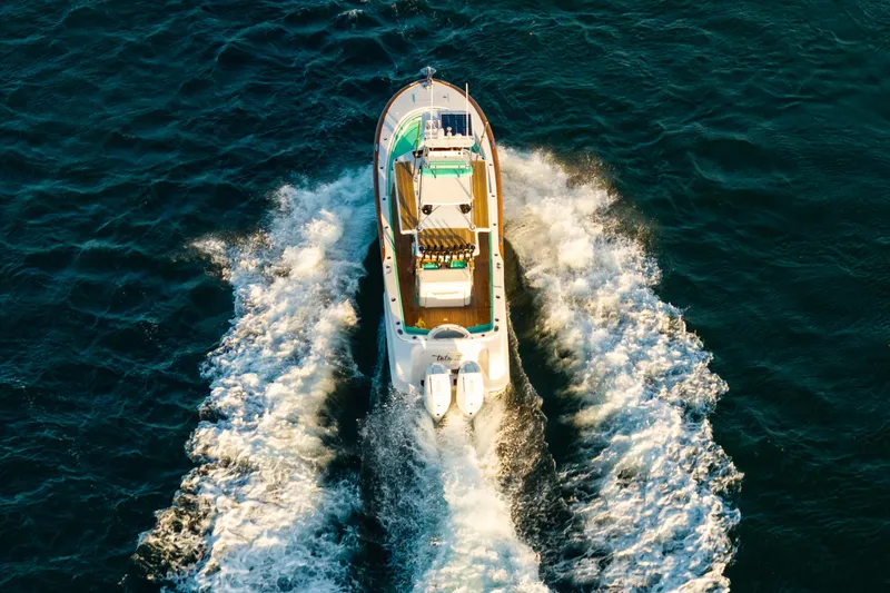 Toto II Yacht Photos Pics Aerial view of 2019 Mag Bay 33 CC boat cruising on open water.