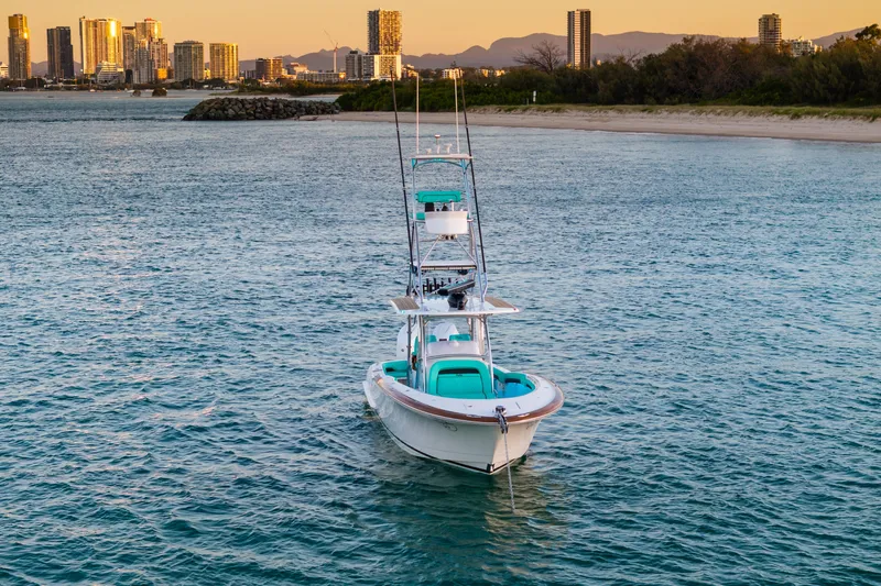 Toto II Yacht Photos Pics 2019 Mag Bay 33 CC boat on water with city skyline in background.