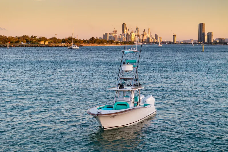 Toto II Yacht Photos Pics 2019 Mag Bay 33 CC boat on water with city skyline in background.