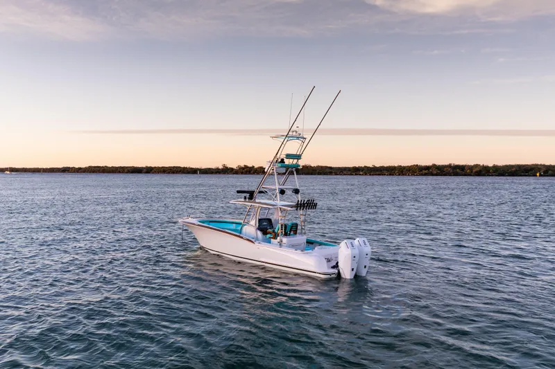 Toto II Yacht Photos Pics 2019 Mag Bay 33 CC boat on calm water at sunset.