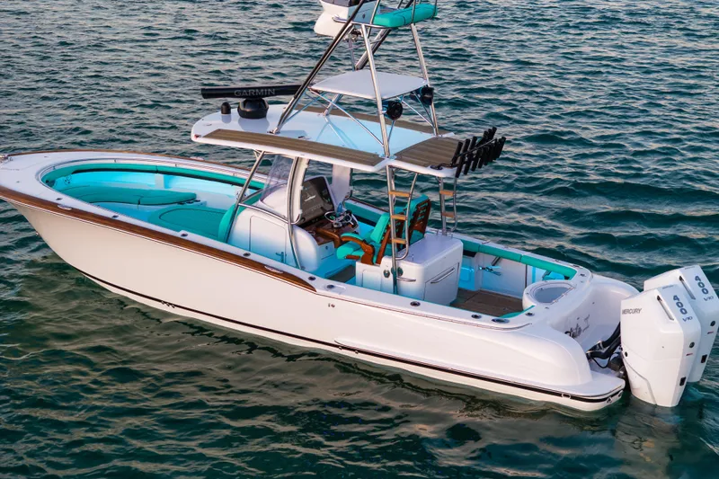 Toto II Yacht Photos Pics 2019 Mag Bay 33 CC boat on water, featuring sleek design and twin Mercury engines.
