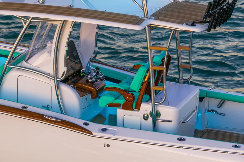 Toto II Yacht Photos Pics 2019 Mag Bay 33 CC boat interior with turquoise seating and wooden accents on the water.