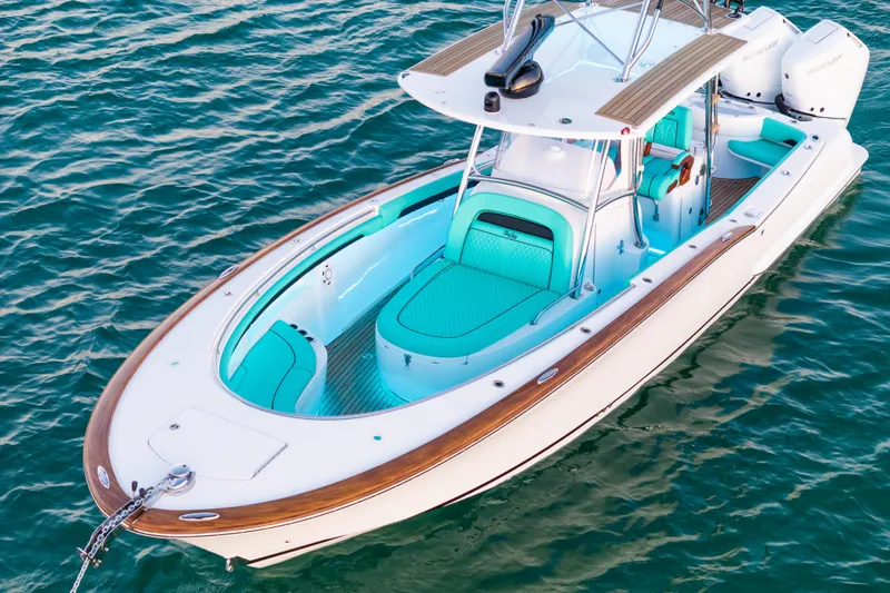 Toto II Yacht Photos Pics 2019 Mag Bay 33 CC boat with turquoise seating on calm water.