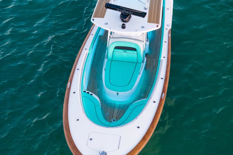 Toto II Yacht Photos Pics 2019 Mag Bay 33 CC boat with turquoise seating, viewed from above on water.